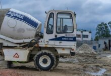Large industrial construction site with cranes and steel framework being built