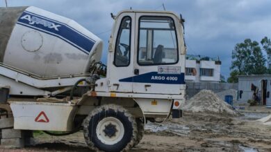 Large industrial construction site with cranes and steel framework being built