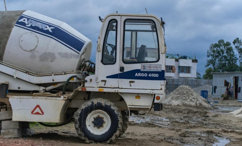 Large industrial construction site with cranes and steel framework being built