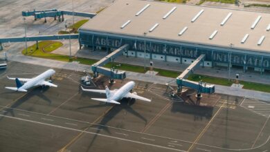 Empty airport terminal with departure boards showing canceled flights during severe weather