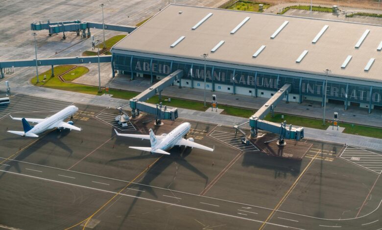 Empty airport terminal with departure boards showing canceled flights during severe weather