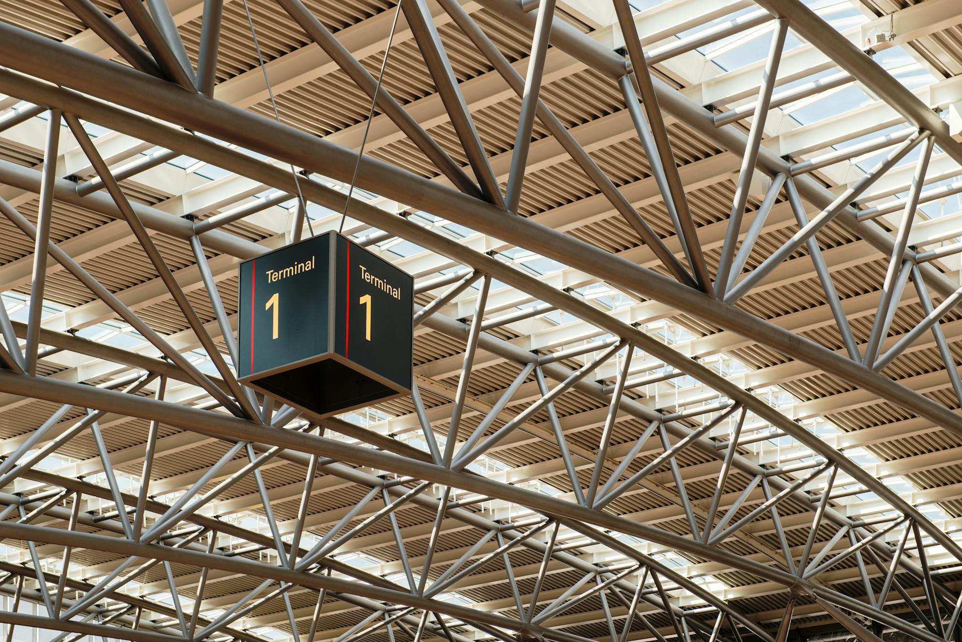 Crowded airport terminal with passengers waiting near departure gates during flight delays