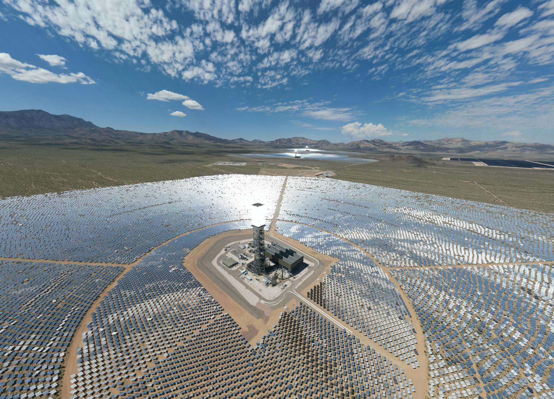 Large-scale solar panel installation in desert landscape under bright sunshine