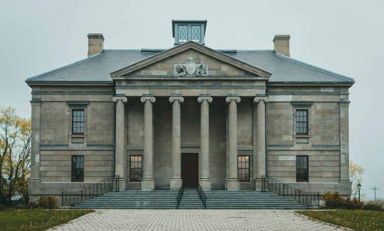 Modern government building with Canadian flag, representing provincial policy implementation
