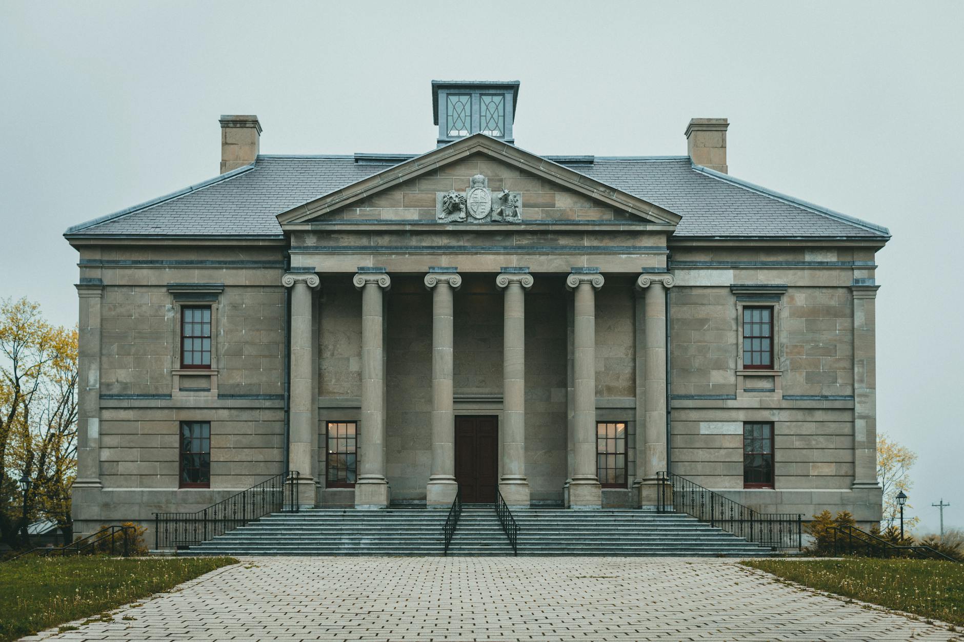 Modern government building with Canadian flag, representing provincial policy implementation