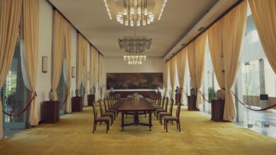 Representatives at diplomatic negotiation table with national flags
