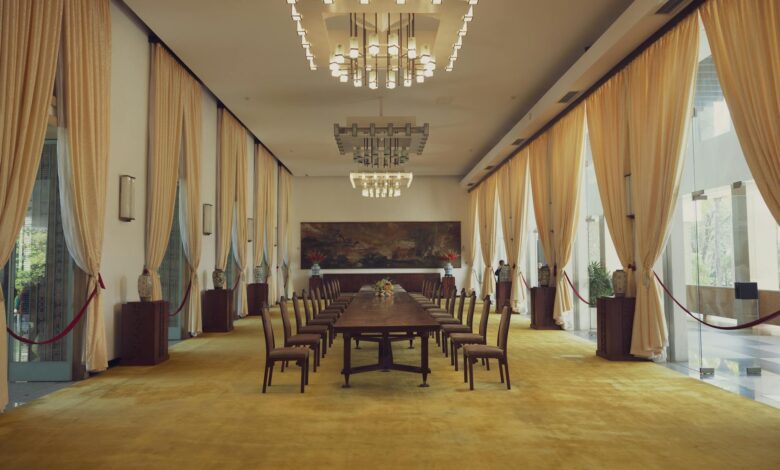 Representatives at diplomatic negotiation table with national flags