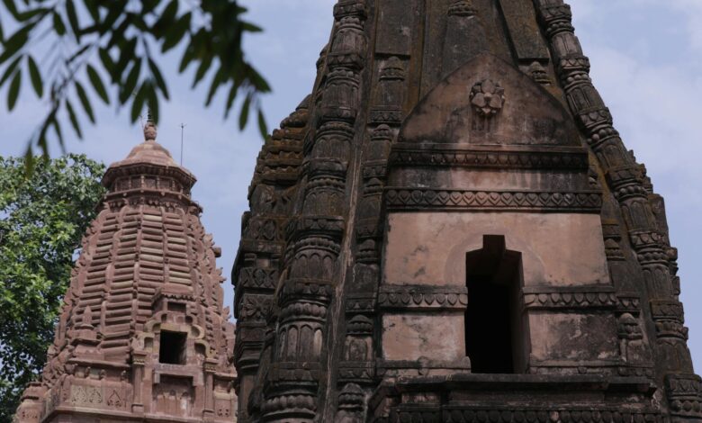Ancient stone temple entrance with carved hieroglyphics and pillars