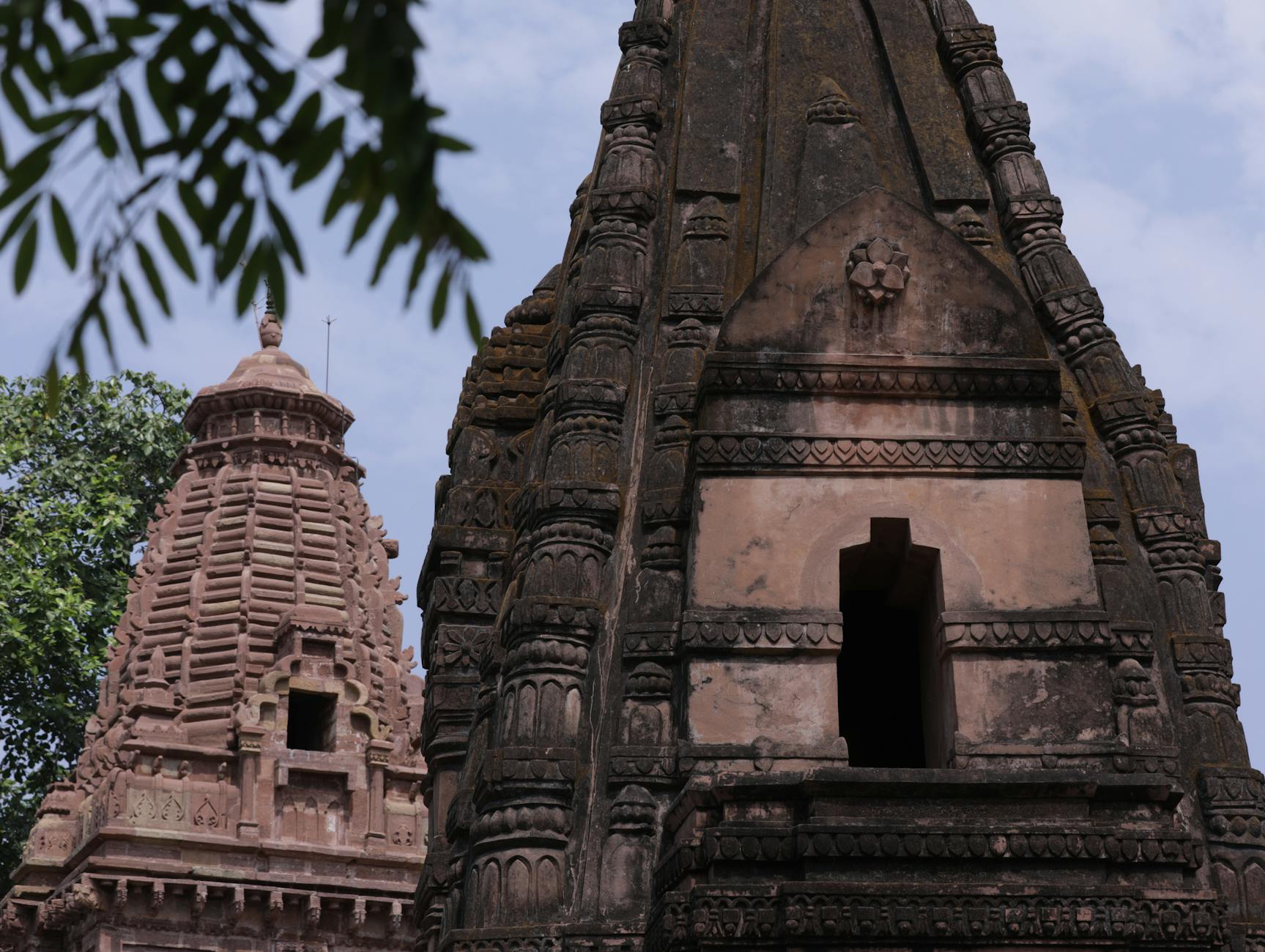 Ancient stone temple entrance with carved hieroglyphics and pillars