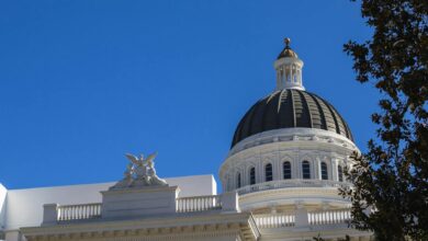 State capitol building dome against blue sky representing state government authority