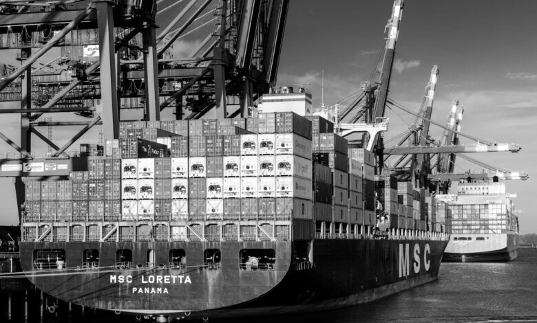 Large container ship loaded with colorful shipping containers on water