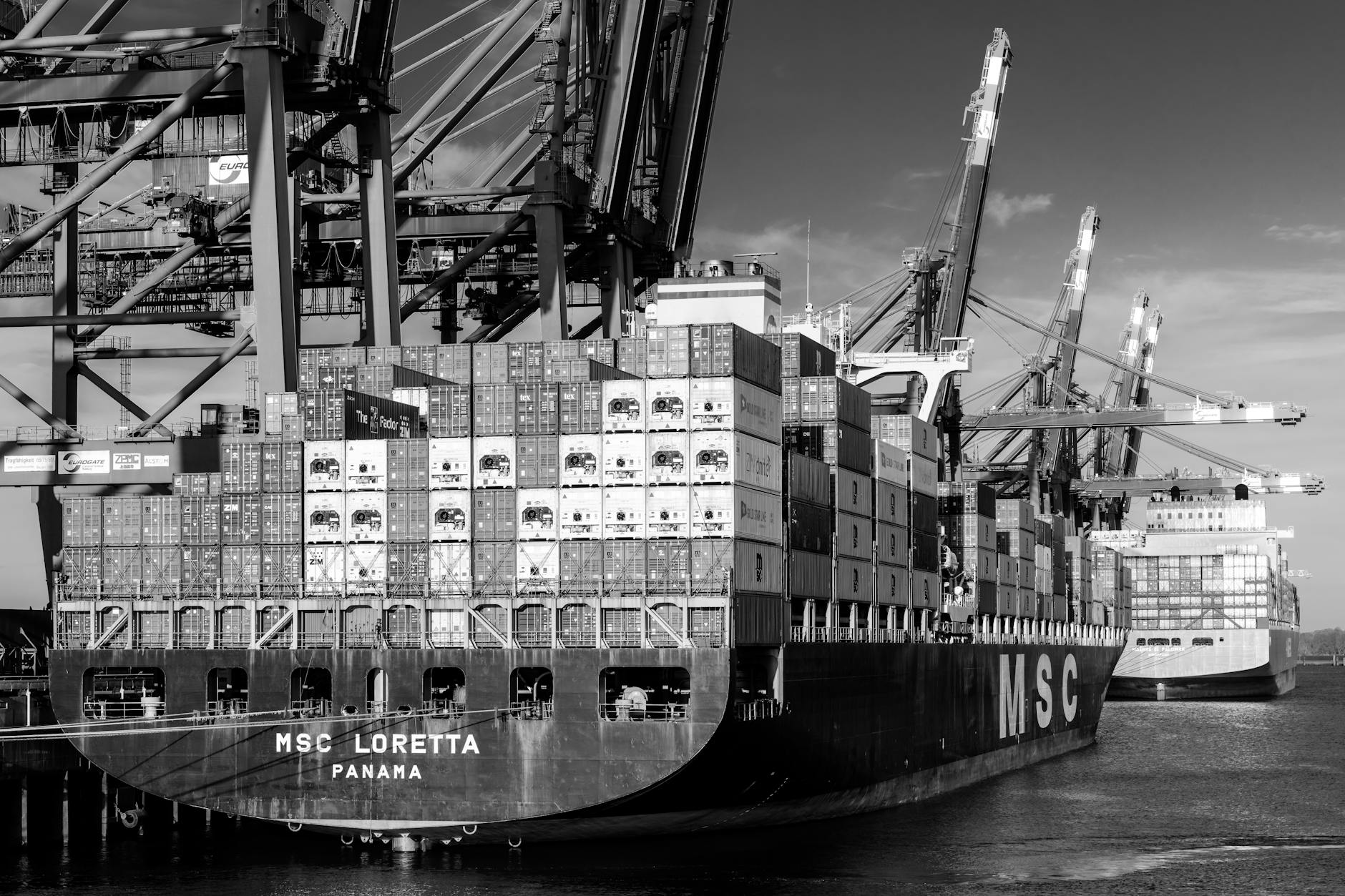 Large container ship loaded with colorful shipping containers on water