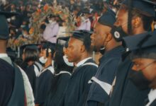 College graduates in caps and gowns celebrating at commencement ceremony
