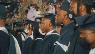 College graduates in caps and gowns celebrating at commencement ceremony