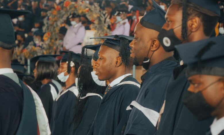 College graduates in caps and gowns celebrating at commencement ceremony