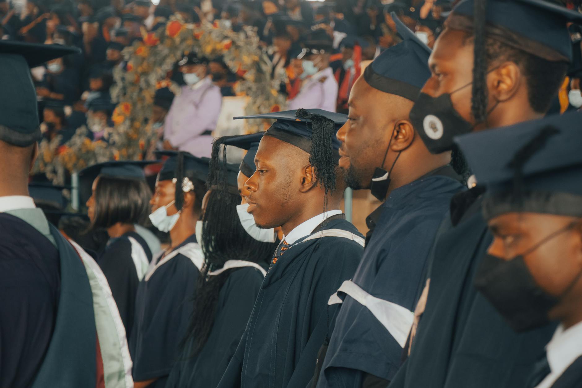 College graduates in caps and gowns celebrating at commencement ceremony