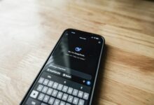 Close-up of smartphone displaying social media apps and notifications on screen