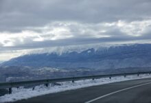 Snow-covered interstate highway with poor visibility conditions during winter storm