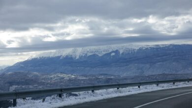 Snow-covered interstate highway with poor visibility conditions during winter storm