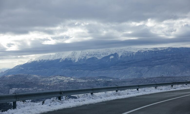 Snow-covered interstate highway with poor visibility conditions during winter storm