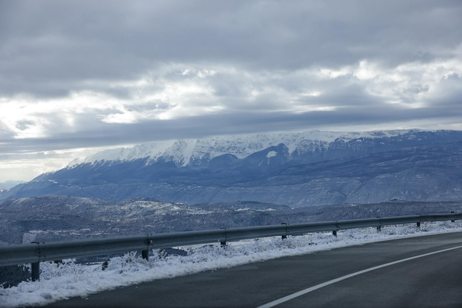 Snow-covered interstate highway with poor visibility conditions during winter storm
