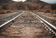 Railroad tracks running through rural countryside area
