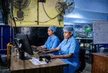 Manufacturing workers in industrial setting representing automotive production workforce