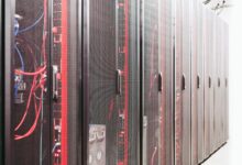 Modern data center server room with rows of network equipment and blue lighting