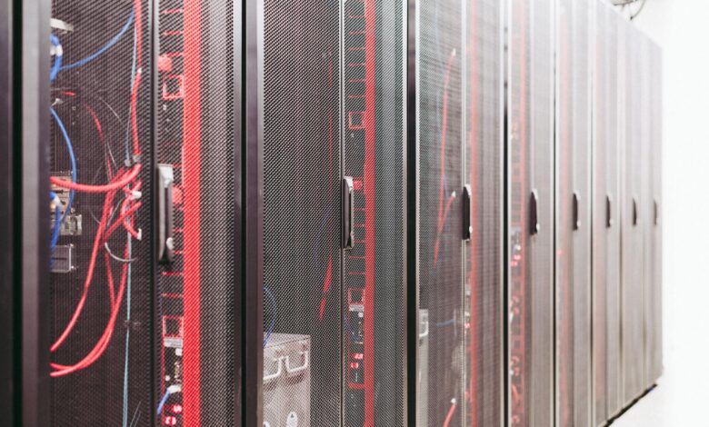 Modern data center server room with rows of network equipment and blue lighting
