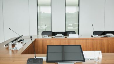 Empty conference room with chairs around large table representing political leadership meetings
