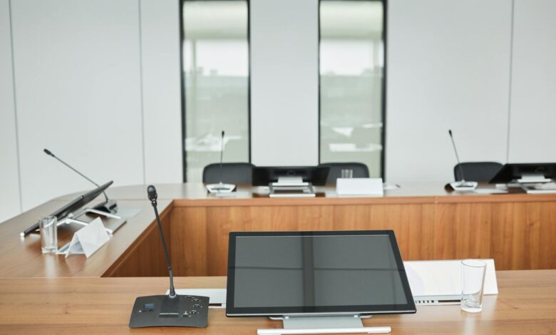 Empty conference room with chairs around large table representing political leadership meetings