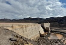 Aerial view of dried up reservoir showing cracked earth and minimal water levels during severe drought conditions