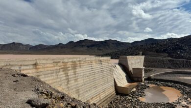 Aerial view of dried up reservoir showing cracked earth and minimal water levels during severe drought conditions