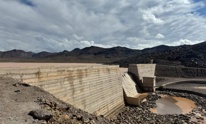 Aerial view of dried up reservoir showing cracked earth and minimal water levels during severe drought conditions