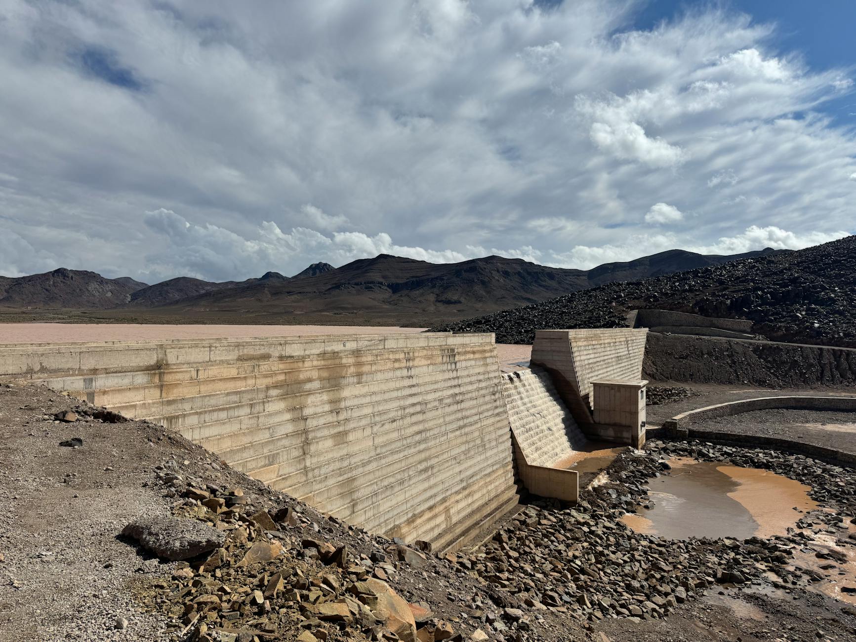 Aerial view of dried up reservoir showing cracked earth and minimal water levels during severe drought conditions