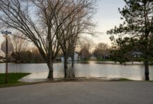 Flooded residential area with water covering streets and reaching building foundations