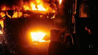 Large industrial fire with thick black smoke rising into the sky