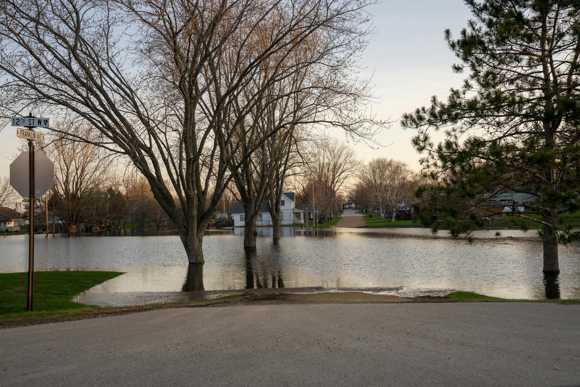 Aerial view of flooded residential area with houses partially submerged in muddy water