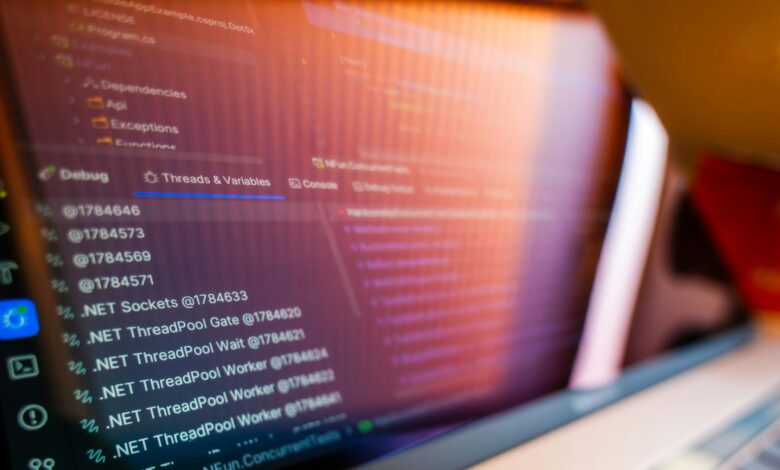 Multiple computer monitors displaying banking system interfaces and security alerts