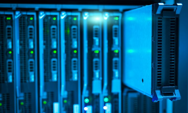 Modern data center server room with rows of computing equipment and blue lighting