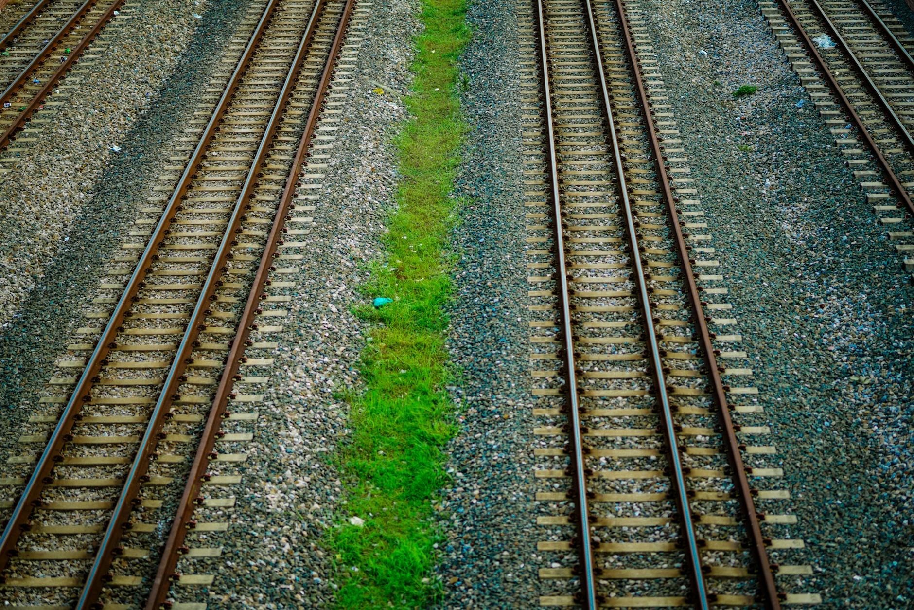 Railroad tracks stretching into the distance through rural landscape