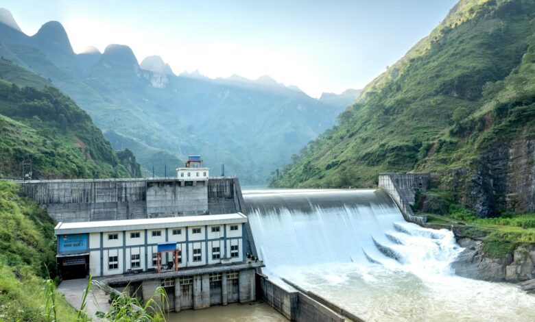 Large hydroelectric dam structure with water flowing through spillways