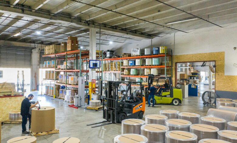 Large warehouse interior with high shelves and shopping carts, representing wholesale retail environment