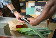 Modern retail checkout counter with traditional cashier station and payment terminal