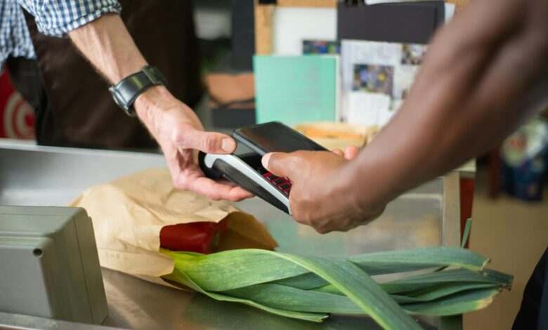 Modern retail checkout counter with traditional cashier station and payment terminal
