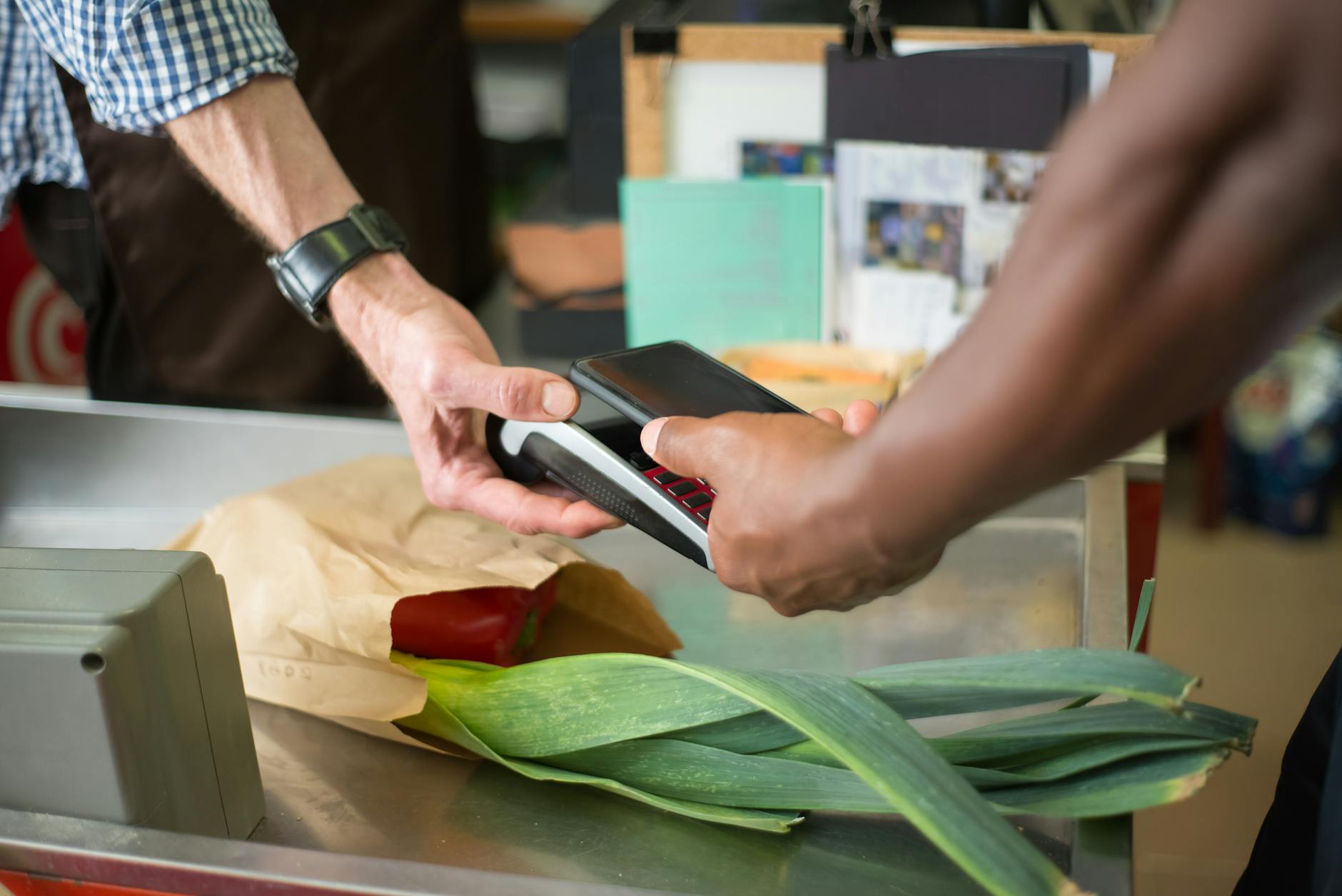 Modern retail checkout counter with traditional cashier station and payment terminal