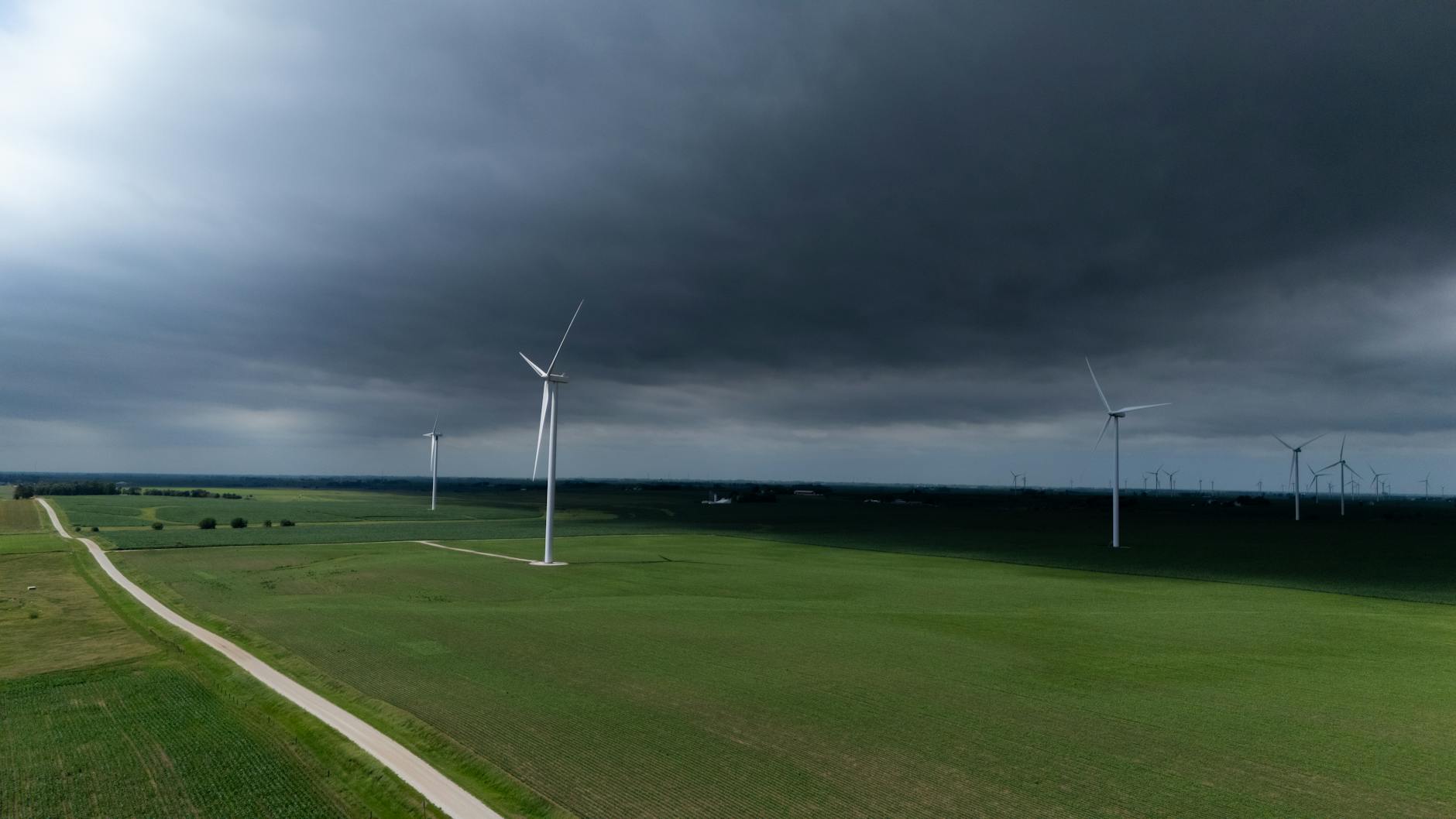 Modern wind turbines generating renewable energy in open landscape