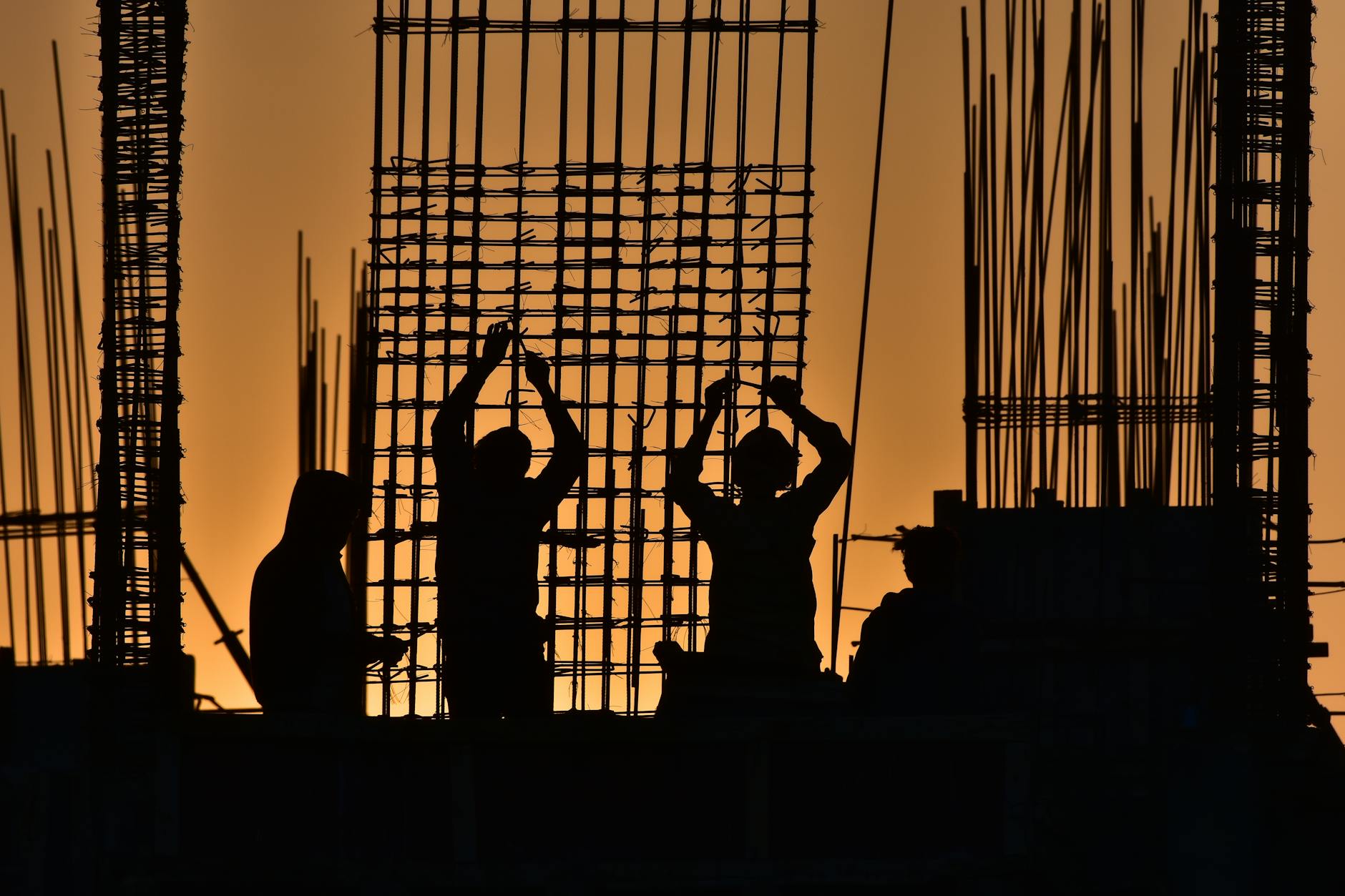 Industrial workers in hard hats working on large-scale energy infrastructure project