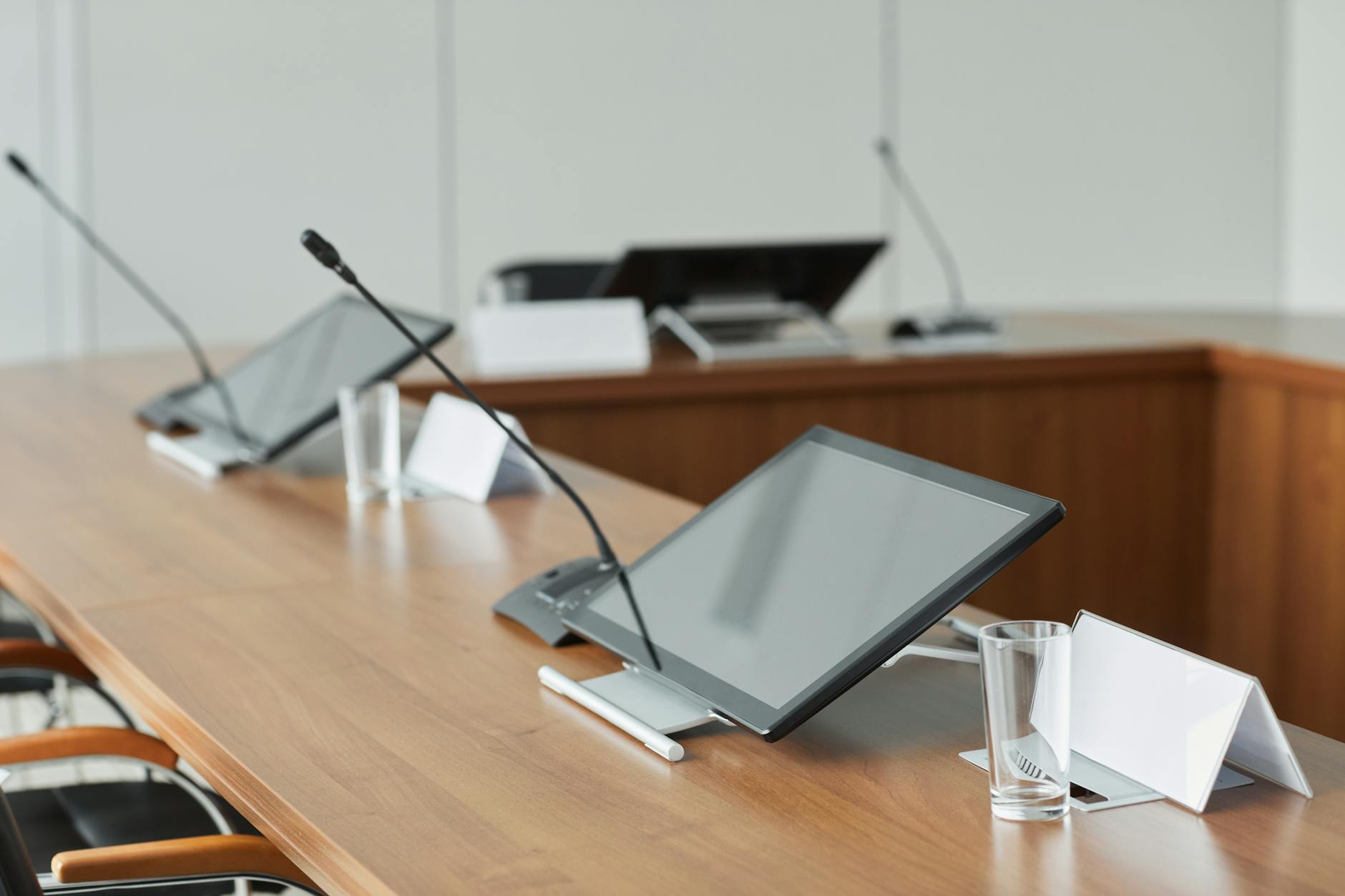 Empty conference room with long table and chairs where political negotiations and committee meetings take place