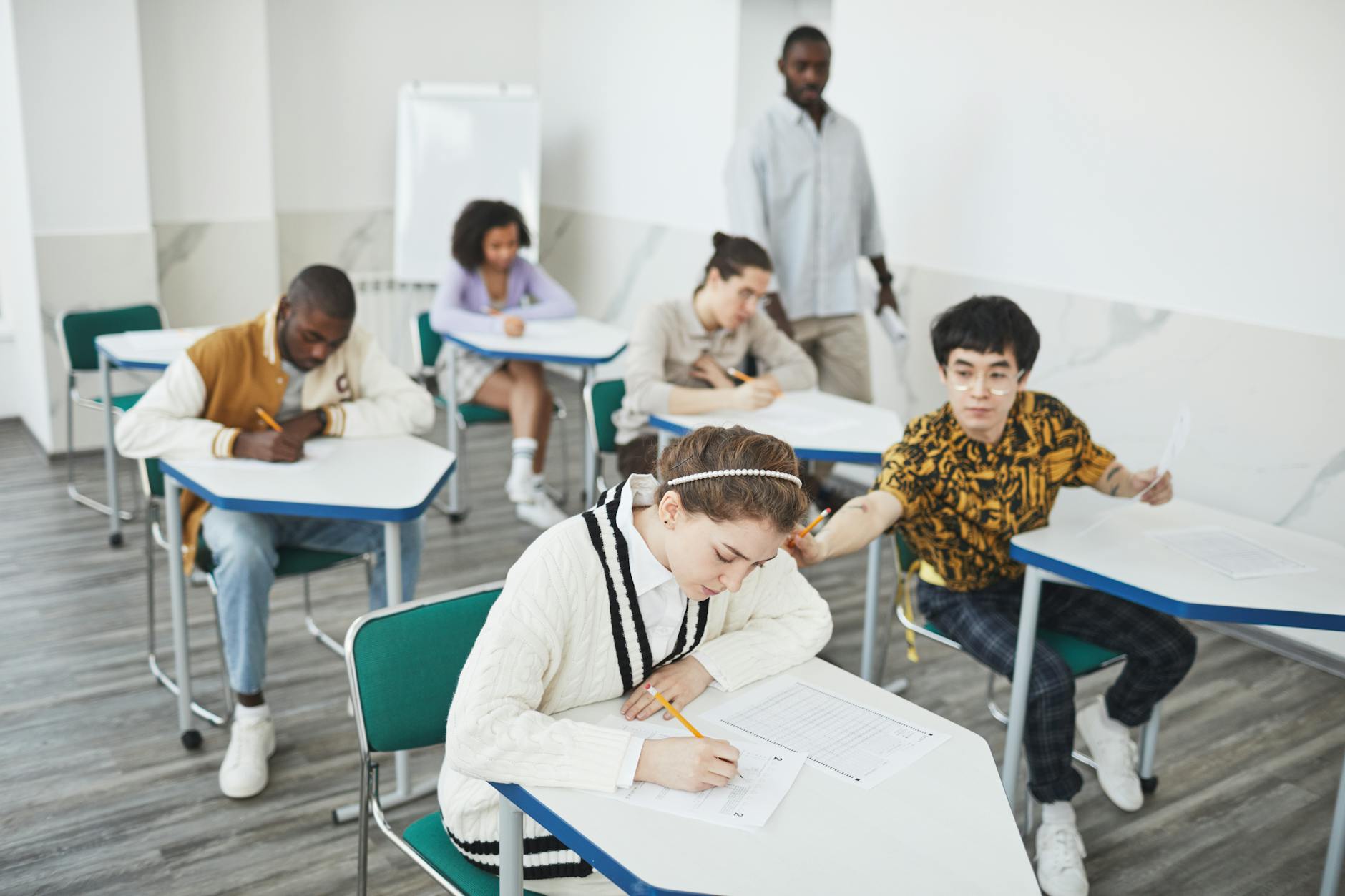 Students sitting at desks in classroom representing education policy impacts